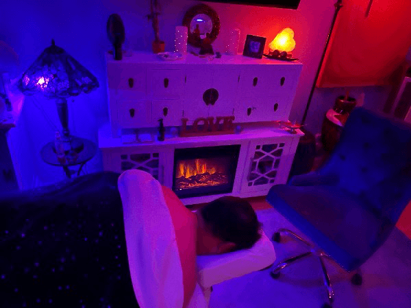 Cozy massage relaxation area with fireplace and starlight ambiance