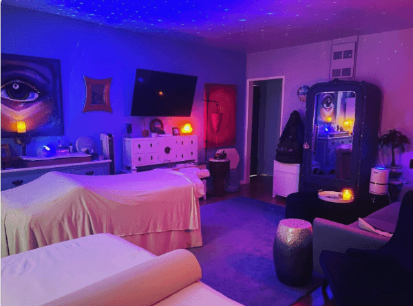 Just What You Knead treatment room with starlight ceiling and ambient purple lighting